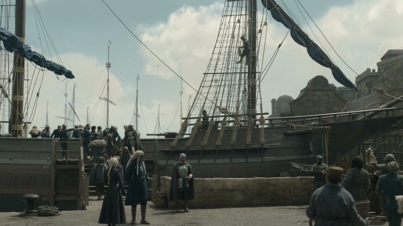 A moored ship's rigging over a busy quay